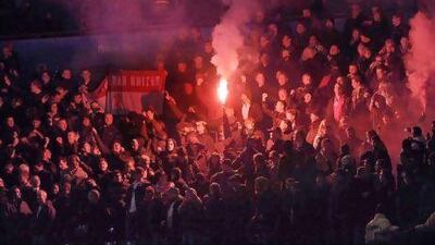 Manchester United fans let off flares before their match against Manchester City.