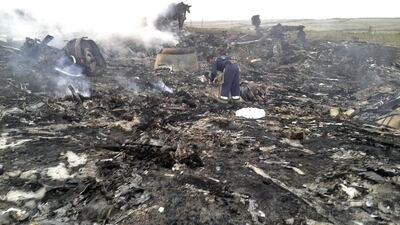An emergency worker sifts through the wreckage of a Malaysia Airlines Boeing 777 plane that crashed in the settlement of Grabovo in the Donetsk region of Ukraine on July 17, 2014. Maxim Zmeyev/ Reuters
