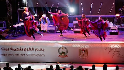 People perform during events to mark the lightning of the Christmas tree at Manger Square, outside the Church of the Nativity in Bethlehem. Reuters