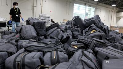 A worker prepares to take bags of ballots to be sorted and processed by the Los Angeles County Registrar. Keith Birmingham/The Orange County Register via AP