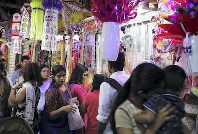 Worshippers buy decorative items for Diwali close to Bur Dubai's small Hindu temple. Pawan Singh / The National
