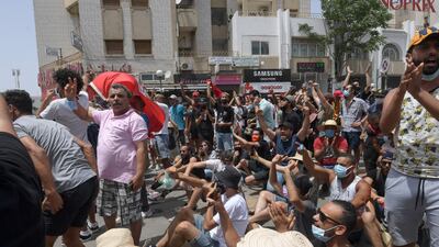 Tunisian anti-government protesters chant slogans as they rally in front of the Parliament in the capital Tunis.