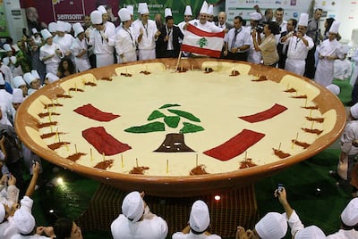 Lebanese chefs celebrate around a large plate of hummus after setting a world record in Beirut, October 24, 2009. AFP