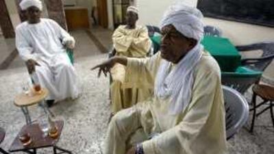 Sudanese expatriates, from left, Rasheen Mohd al Amin, Babekir Ahmed Daffalla, and Yousif Ahmed el Neel discuss the elections in their home country at the Sudanese Social Club in Dubai.