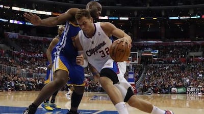 Los Angeles Clippers' Blake Griffin looks for a way past Carl Landry of the Golden State Warriors.