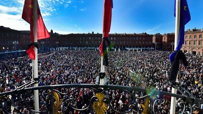 Flags at city hall are at half-mast as people gather in Place du Capitole in Toulouse. AFP