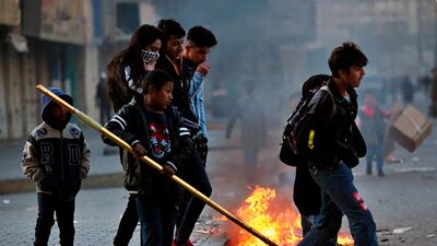 Anti-government protesters set fire during clashes with security forces in Baghdad. AP Photo