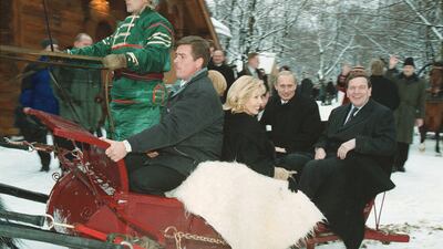 Gerhard Schroeder, far right, rides in a Russian sleigh with Vladimir Putin, second right, on a visit to Moscow in 2001.