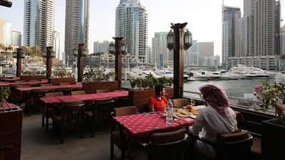 Diners enjoy the view at the Dubai Marina waterfront. Kamran Jebreili / AP Photo