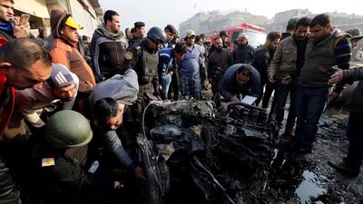 People inspect the site of a car bomb attack at a vegetable market in eastern Baghdad, Iraq January 8, 2017. Wissm Al Okili/Reuters