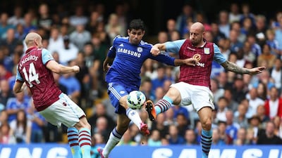 Chelsea's Diego Costa kicks at the ball against Aston Villa's Alan Hutton, right, and Philippe Senderos, left, during Chelsea's Premier League victory at Stamford Bridge on Saturday. Kieran Galvin / EPA