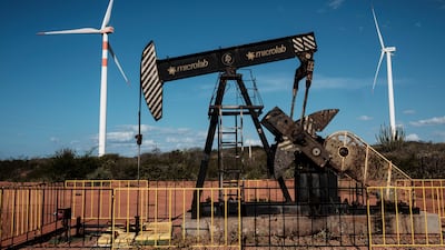 An oil drilling platform and wind turbines in Serra do Mel, Rio Grande do Norte state, Brazil. AFP