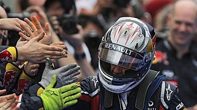 Red Bull Racing driver Sebastian Vettel takes the plaudits in the pit lane following his victory in a 'complicated' Malaysia Grand Prix yesterday.