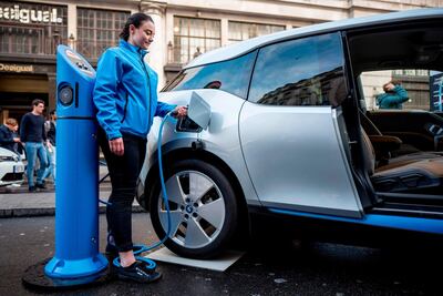A BMW i3 electric vehicle (EV) connected to to a charging point in London. AFP