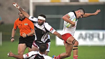 The UAE's Adel Al Hendi, right, escapes the grasp of Jordan's Laith Jalajel (3) and Mohammad Abu Samra (12) during their match for third place in the Asian Rugby Football Union Development Sevens 2014 tournament at the Al Ain Rugby Club in Al Ain, November 1, 2014. The UAE defeated Jordan 26-7. Jeff Topping / The National