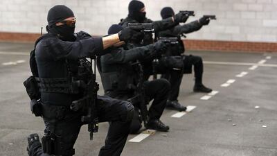 Police firearms officers hold their weapons as they take part in a live firing training exercise. AFP