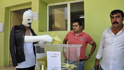 A man wounded in bomb blasts at a rally of the pro-Kurdish People’s Democratic Party in Diyarbakir two days before Turkey’s general election casts his vote in the south-eastern city on June 7. Ilyas Akengin / AFP