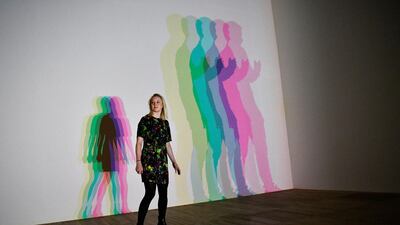 A woman poses with Danish-Icelandic artist Olafur Eliasson's work 'Your Uncertain Shadow' (2010) at the Tate Modern in London, Britain, 09 July 2019. Photo: EPA