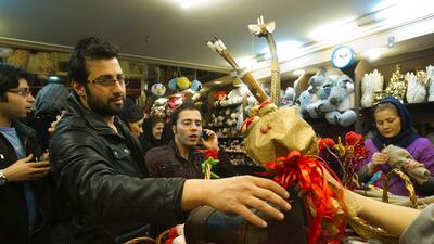 An Iranian man buys a gift during Valentine's day shopping at a shop in Tehran February 13, 2012. REUTERS/Raheb Homavandi