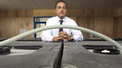 Manzi at his water purification plant in Barsha: "This is pure water... it tries to revert back to its natural state. It actually draws in the dirt."