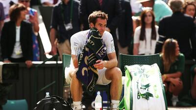 Britain's Andy Murray sits down after losing his Wimbledon men's singles quarter-final against Bulgaria's Grigor Dimitrov on July 2, 2014. Andrew Yates / AFP