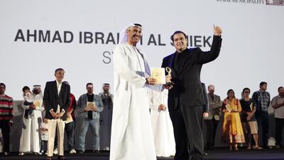 Hussain Lootah, director general of Dubai Municipality, presents Syrian Ahmed Al Shiekh, 27, with an award for being the winner of the Your Weight in Gold campaign by losing 26kg, dropping from 146kg to a final weight of 120kg. Sarah Dea / The National