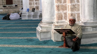 A Palestinian elder reads from the Quran before at Al Omari mosque in Gaza City. EPA