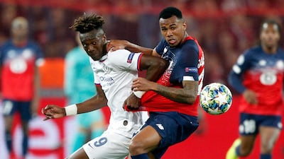 Chelsea's Tammy Abraham, left, fights for the ball with Lille's Gabriel. AP Photo