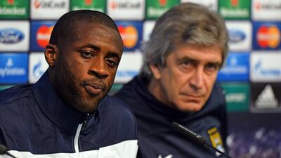Yaya Toure, left, and Manuel Pellegrini say they are confident about their chances of success against Barcelona in Tuesday night's Uefa Champions League quarter-final first leg at the Etihad Stadium. Paul Ellis / AFP