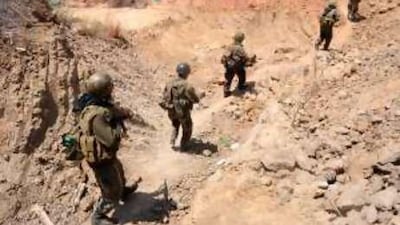 Sri Lankan government troops advancing along a trench in the forward defence line in Kilinochchi, the Tamil Tiger administrative capital in the island's north.