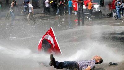 A man is hit by water cannon during protests in Ankara on Saturday. Umit Bektas / Reuters
