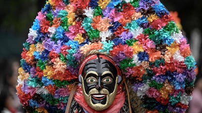 A Mexican traditional dancer takes part in the Alebrijes Parade, celebrating folk art and handicrafts, before the Day of the Dead celebrations in Mexico City. AFP
