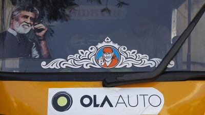 Promotional stickers for ride-hailing service Ola are displayed on an auto rickshaw in Bengaluru, India. Namas Bhojani / Bloomberg