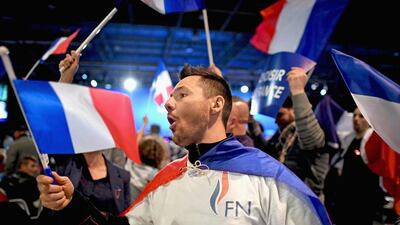 Supporters of presidential candidate Marine Le Pen wave the French flag during her election rally on May 1, 2017 in Villepinte, France. Jeff J Mitchell / Getty Images