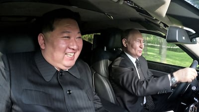 Mr Putin and Mr Kim ride in a car in Pyongyang. Reuters