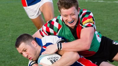 The Jebel Ali Dragons (blue) and Abu Dhabi Harliquins (green) in action on Friday. Duncan Chard for the National