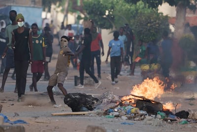A demonstrator throws a rock at police during a protest at a neighborhood in Dakar, Senegal, on June 3. The clashes first broke out after opposition leader Ousmane Sonko was convicted of corrupting youth and sentenced to two years in prison. AP