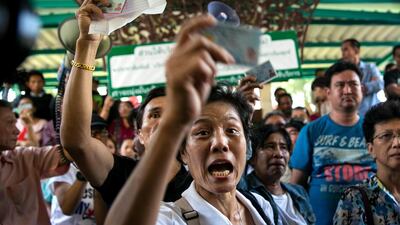 Bangkok residents fight with police and officials protesting against not being able to cast their ballot because of blocked on Sunday. Paula Bronstein / Getty Images