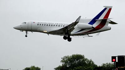 A plane carrying French president Emmanuel Macron lands at RAF Northolt for his visit to Britain. PA via AP