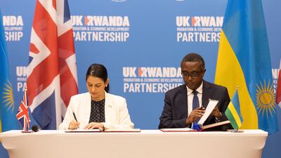 British Home Secretary Priti Patel, left, with Rwandan Foreign Minister Vincent Biruta, signs a migration and economic development partnership between the UK and Rwanda in Kigali, Rwanda. EPA