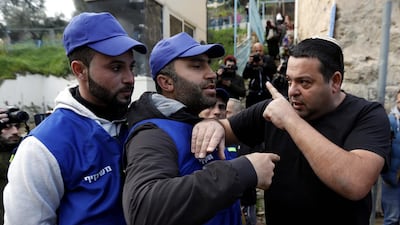 An Israeli settler (R) argues with Palestinians wearing blue vests marking them as 'Observers' during a protest against the end of the mandate for the civilian Temporary International Presence in Hebron (TIPH) in the West Bank city of Hebron, 10 February 2019. EPA