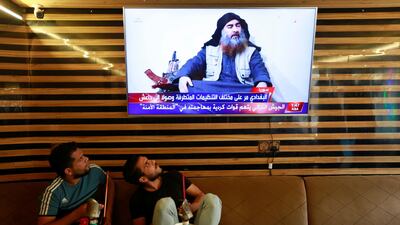Iraqi youth watch the news of ISIS leader Abu Bakr Al Baghdadi's death in Najaf, Iraq on October 27, 2019. Reuters