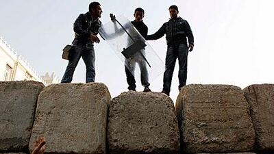 Protesters on one of the barriers set up by the military near Tahrir Square to separate troops from protesters.