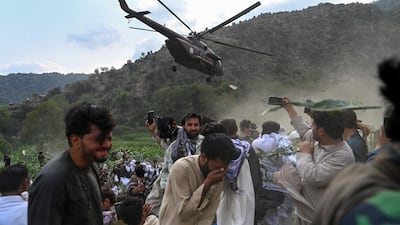 EDITORS NOTE: Graphic content / A military helicopter airlifts injured Afghans after earthquakes at Mazar Dara village in Nurgal district, Kunar province, in Eastern Afghanistan, on September 1, 2025. More than 800 people have died and over 2,700 were injured from August 31 night to September 1, 2025, in eastern Afghanistan after a 6-magnitude earthquake, followed by at least five aftershocks felt hundreds of kilometers away. (Photo by Wakil Kohsar / AFP)