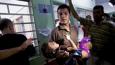 A child wounded in the shelling of a United Nations school in the northern Gaza city of Beit Hanoun is taken into the Kamal Adwan hospital in nearby Beit Lahiya on July 24,2014. Witnesses said the school, in which about 1,500 Palestinians had taken shelter, was hit by Israeli tank shells. Heidi Levine for The National