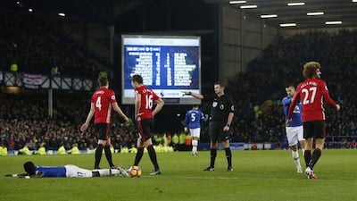 Referee Michael Oliver points to the penalty spot after Everton’s Idrissa Gueye is fouled by Manchester United’s Marouane Fellaini. Andrew Yates / Reuters