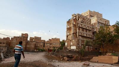 A Yemeni man walks past Unesco-listed buildings in the old city of Yemeni capital Sanaa. Yemen's warring parties have agreed on a ceasefire from April 10 followed by peace talks, a UN envoy said, raising hopes of a breakthrough in a conflict that has devastated the country. Mohammed Huwais/AFP