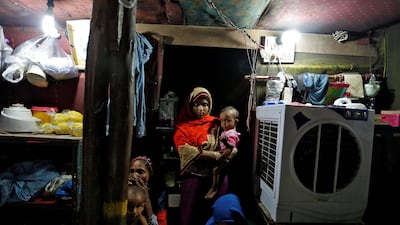 A family from the Rohingya community is pictured inside their shack at a camp in Delhi, India on August 17, 2017. Cathal McNaughton / Reuters