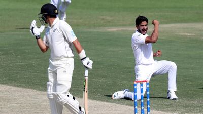 Pakistan bowler Hasan Ali, right, celebrates after dismissing New Zealand batsman Ross Taylor on Day 3 of the first Abu Dhabi Test on Sunday. Chris Whiteoak / The National