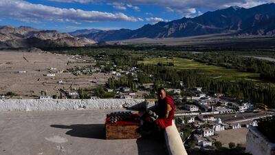 A Buddhist monk looks on as he sits on a rooftop at The Thikse Monastery at Thikse in Ladakh. Chandan Khanna / AFP